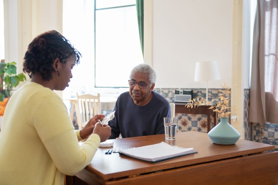 Caregiver assisting an elderly man at home