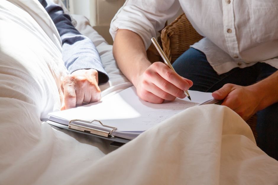Caregiver spending time with a senior in a sunlit room