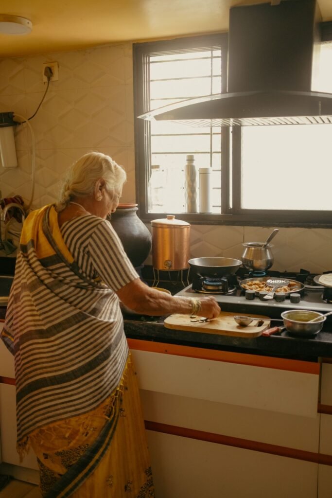 Senior Indian woman cooking in her kitchen