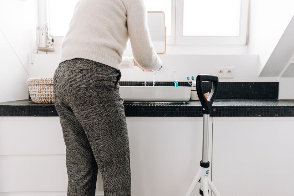 Senior using a bathroom safely with support