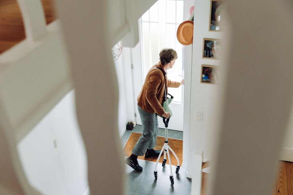 Senior woman using a rollator walker indoors