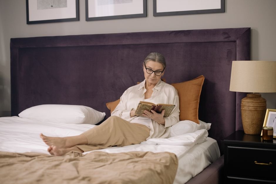 Senior woman relaxing in a cozy bedroom
